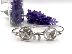 Pulsera rígida de lotus en acero con Trébol